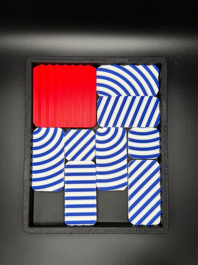 May include: A set of nine tiles with blue and white striped patterns. One tile is solid red.
