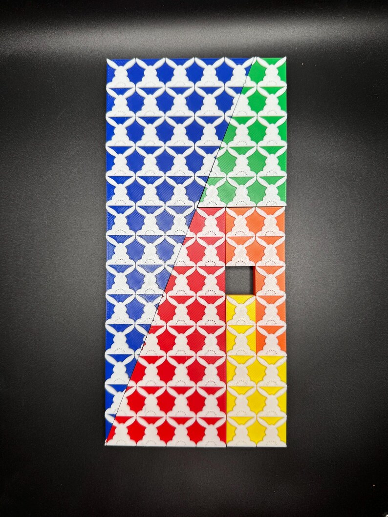 May include: A geometric pattern made of colorful tiles. The tiles are arranged in a diagonal pattern, with the colors blue, green, orange, red, and yellow. The tiles have a white pattern of stylized bunnies on them.