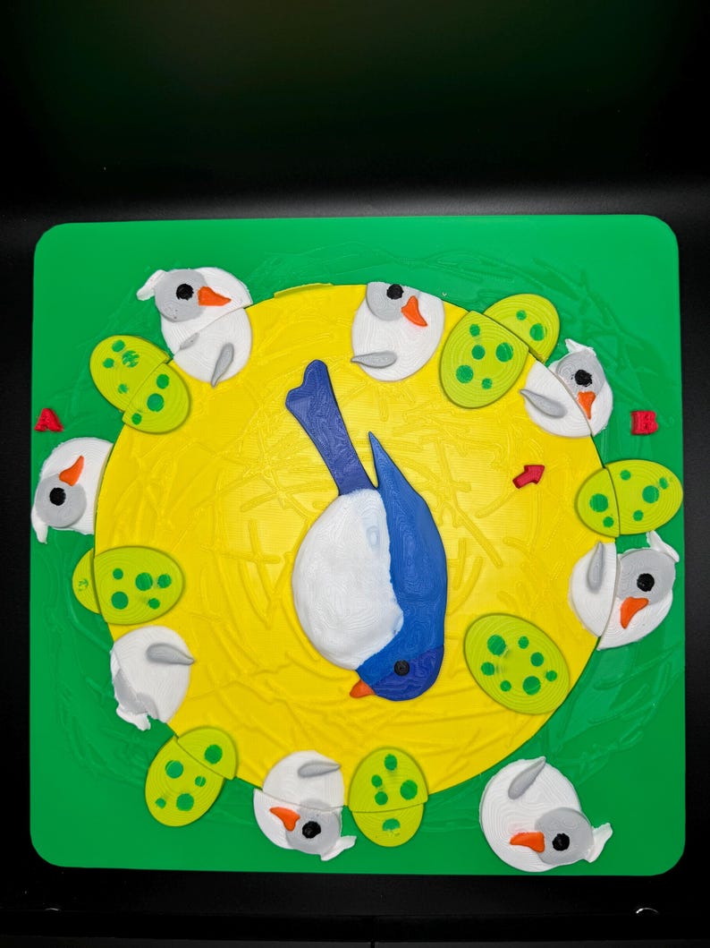 May include: A colorful, handcrafted puzzle featuring a blue and white bird in the center, surrounded by white birds and green, spotted shapes. The puzzle is set against a yellow circle and a green square background.