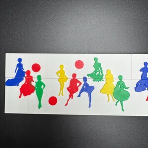 May include: A white surface with a variety of colorful paper cutouts of people in different poses. The cutouts are in shades of blue, red, green, and yellow.