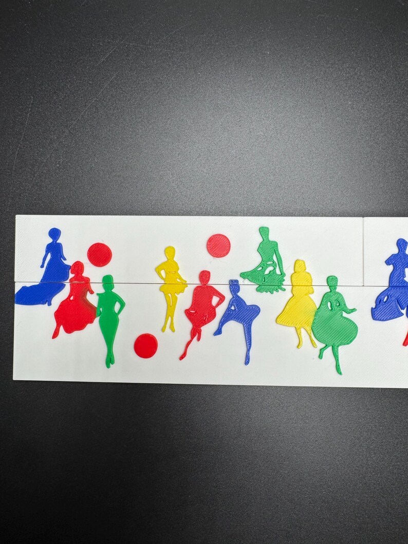 May include: A white surface with a variety of colorful paper cutouts of people in different poses. The cutouts are in shades of blue, red, green, and yellow.