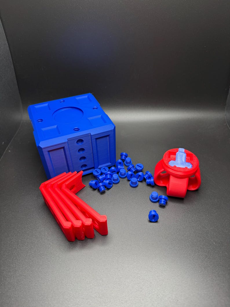 May include: A set of 3D printed parts in red and blue. The set includes a blue box with holes, a red connector with a blue screw, four red brackets, and a pile of blue plastic screws.