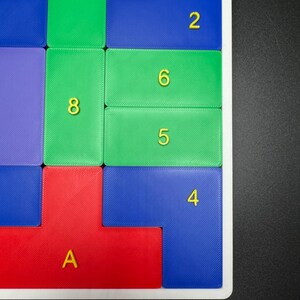 May include: A colorful puzzle game with numbered tiles. The tiles are arranged in a grid pattern and are made of different colors, including red, green, blue, and orange. The numbers on the tiles are 1, 2, 3, 4, 5, 6, 7, 8, 10, and 11.