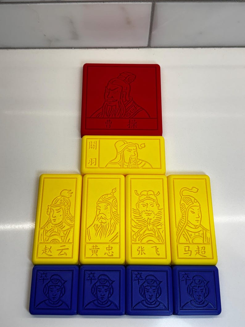 May include: A set of nine colorful game tiles featuring Chinese characters and illustrations. The tiles are arranged in a pyramid shape, with a red tile at the top, followed by two yellow tiles, and then four yellow tiles, and finally four blue tiles at the bottom.