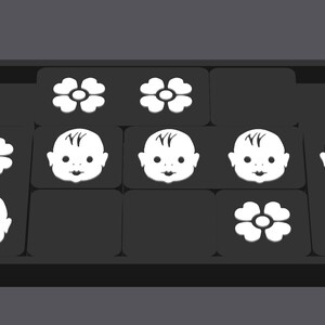 May include: A black tray with nine white tiles. Each tile has a different image: a flower, a baby face, or a flower with a circle in the center.