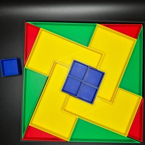 May include: A wooden puzzle with a yellow, green, and red frame. The puzzle pieces are blue and fit together to form a square.