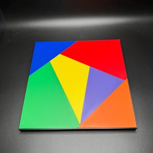May include: A colorful geometric puzzle with six pieces. The pieces are arranged to form a square. The colors of the pieces are red, blue, green, yellow, orange, and purple.