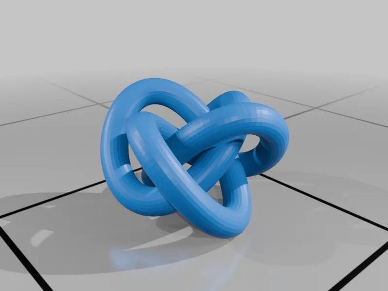 May include: A blue 3D printed knot sculpture. The knot is made of three intertwined loops. The sculpture is on a white tiled surface.