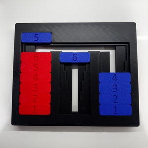 May include: A black frame with a sliding puzzle game. The puzzle has three columns of numbered tiles. The left column has red tiles numbered 1 through 6. The middle column has a blue tile numbered 6. The right column has blue tiles numbered 1 through 4.
