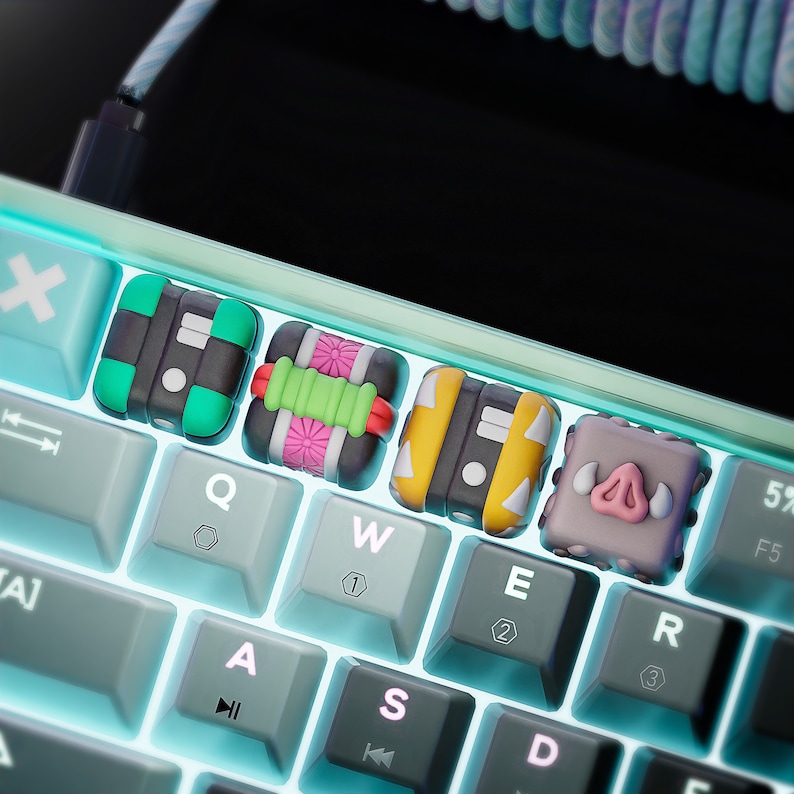 May include: A keyboard with custom keycaps featuring colorful designs. The keycaps are shaped like different characters, including a pig, a flower, and a geometric pattern. The keyboard has a white frame and blue backlighting.