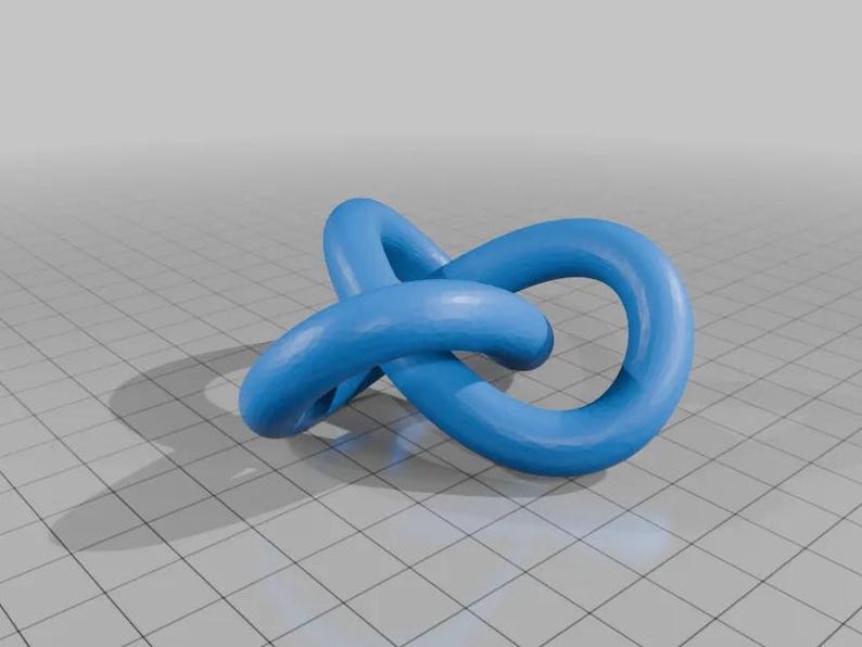 May include: A blue, abstract, 3D printed sculpture in the shape of a knot. The sculpture is made of a smooth, plastic material and has a glossy finish.