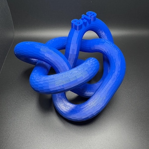 May include: A blue 3D printed knot sculpture with the number "819" printed on the top.