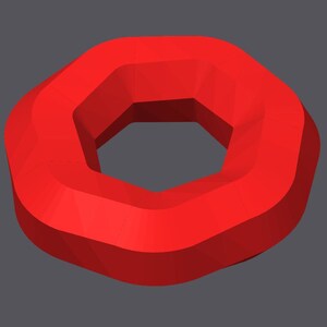 May include: A red, geometric shape resembling a donut with a hexagonal hole in the center.