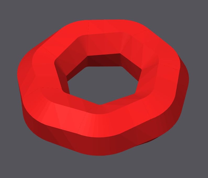 May include: A red, geometric shape resembling a donut with a hexagonal hole in the center.