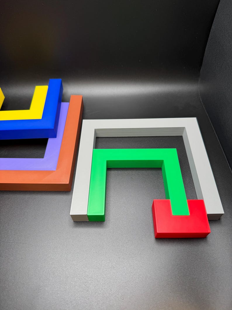 May include: Geometric wooden puzzle pieces in various colors, including blue, yellow, orange, purple, green, red, and gray. The pieces are arranged on a dark surface, showcasing their shapes and colors.