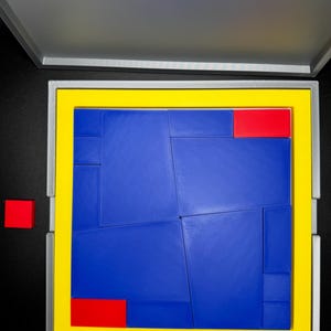 May include: A blue and red puzzle with a yellow frame. The puzzle pieces are arranged in a square shape. The puzzle is in a gray box with a yellow border.