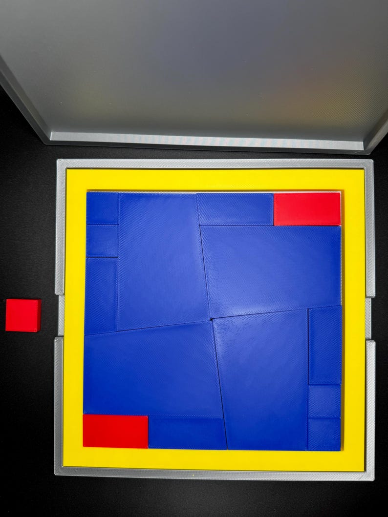 May include: A blue and red puzzle with a yellow frame. The puzzle pieces are arranged in a square shape. The puzzle is in a gray box with a yellow border.