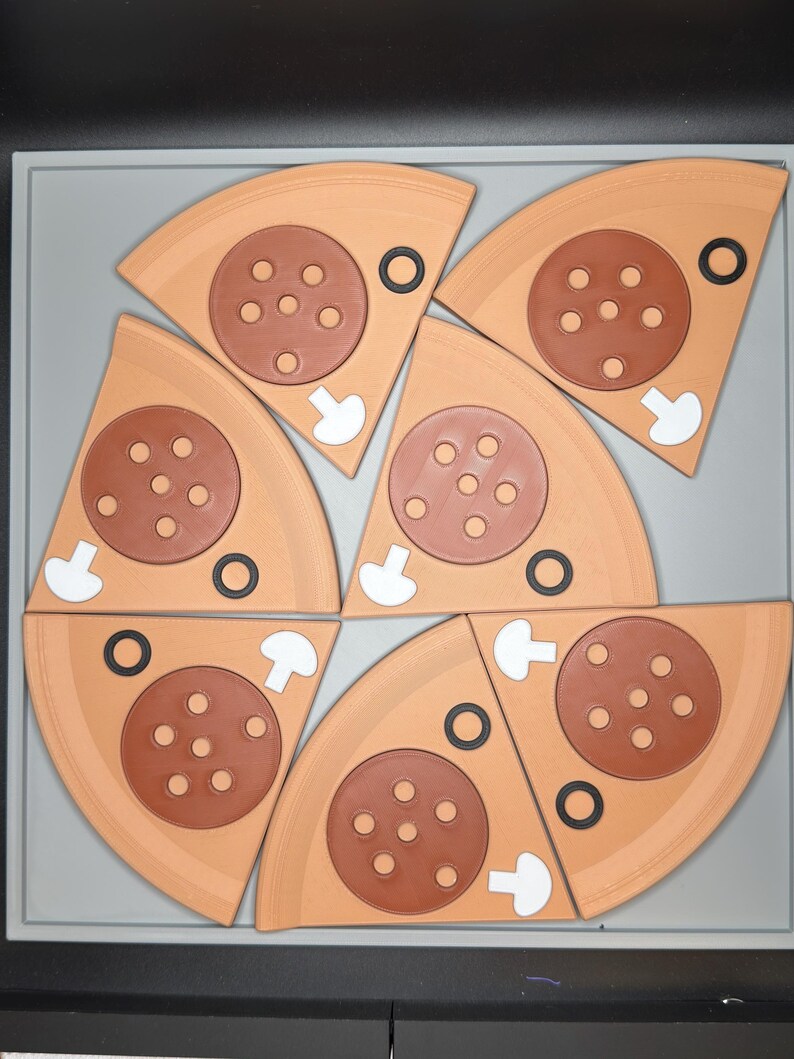 May include: Six triangular pizza slices arranged in a circular pattern. Each slice is light tan with a brown circular pepperoni topping featuring five holes, a small white mushroom slice, and a small black olive ring on the crust area.