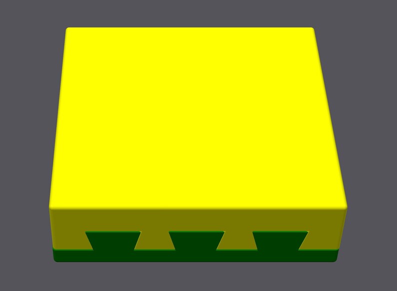 May include: A yellow square block with a green base. The base has a series of five evenly spaced, triangular cutouts.