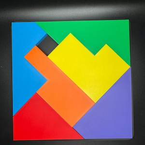 May include: A colorful wooden puzzle with six pieces in different shapes and colors: blue, green, yellow, orange, red, and purple. The pieces fit together to form a square.