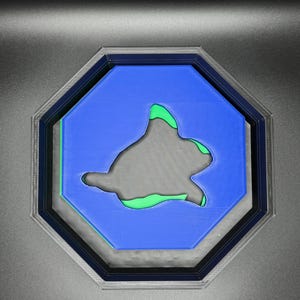 Op de afbeelding: Een blauw, achthoekig bord met een groen silhouet van een schildpad erin.