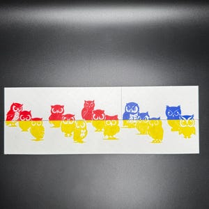 May include: A row of colorful owl illustrations, with red, blue, and yellow owls. The owls are arranged in a line, with the red owls on top and the blue and yellow owls on the bottom.