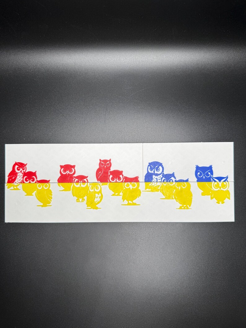 May include: A row of colorful owl illustrations, with red, blue, and yellow owls. The owls are arranged in a line, with the red owls on top and the blue and yellow owls on the bottom.