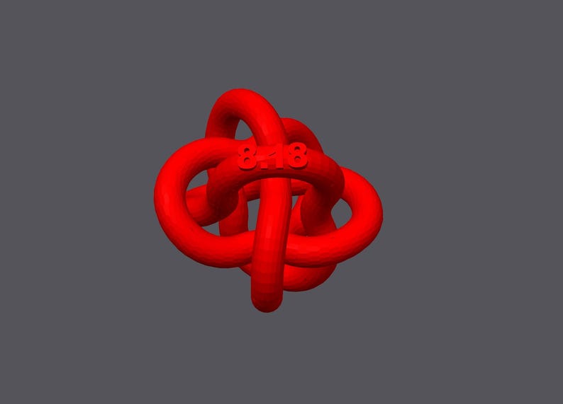 May include: A red, three-dimensional knot with the number "8418" embossed on it.