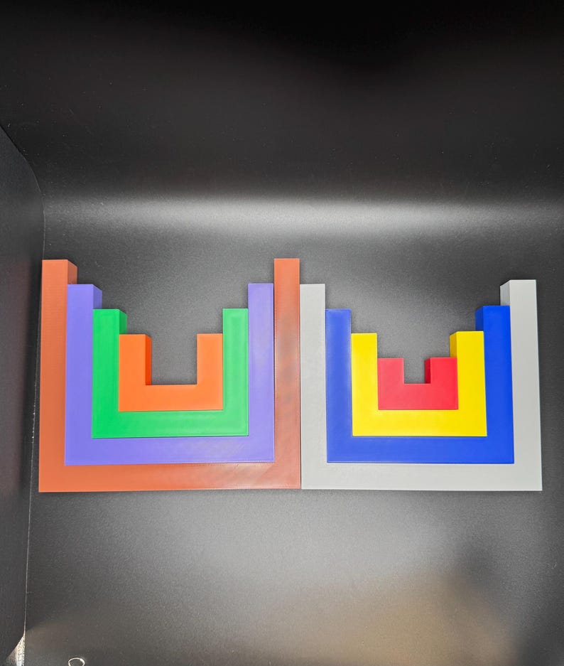 May include: Two colorful wooden block puzzles. One puzzle features orange, green, purple, and brown blocks. The other puzzle has red, yellow, blue, and gray blocks. The blocks are arranged in a square shape.