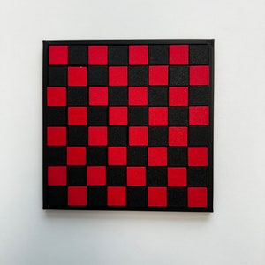 May include: A black and red checkerboard with a black frame. The checkerboard is made of small squares.