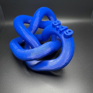 May include: A blue 3D printed knot sculpture with the number "819" printed on the side.