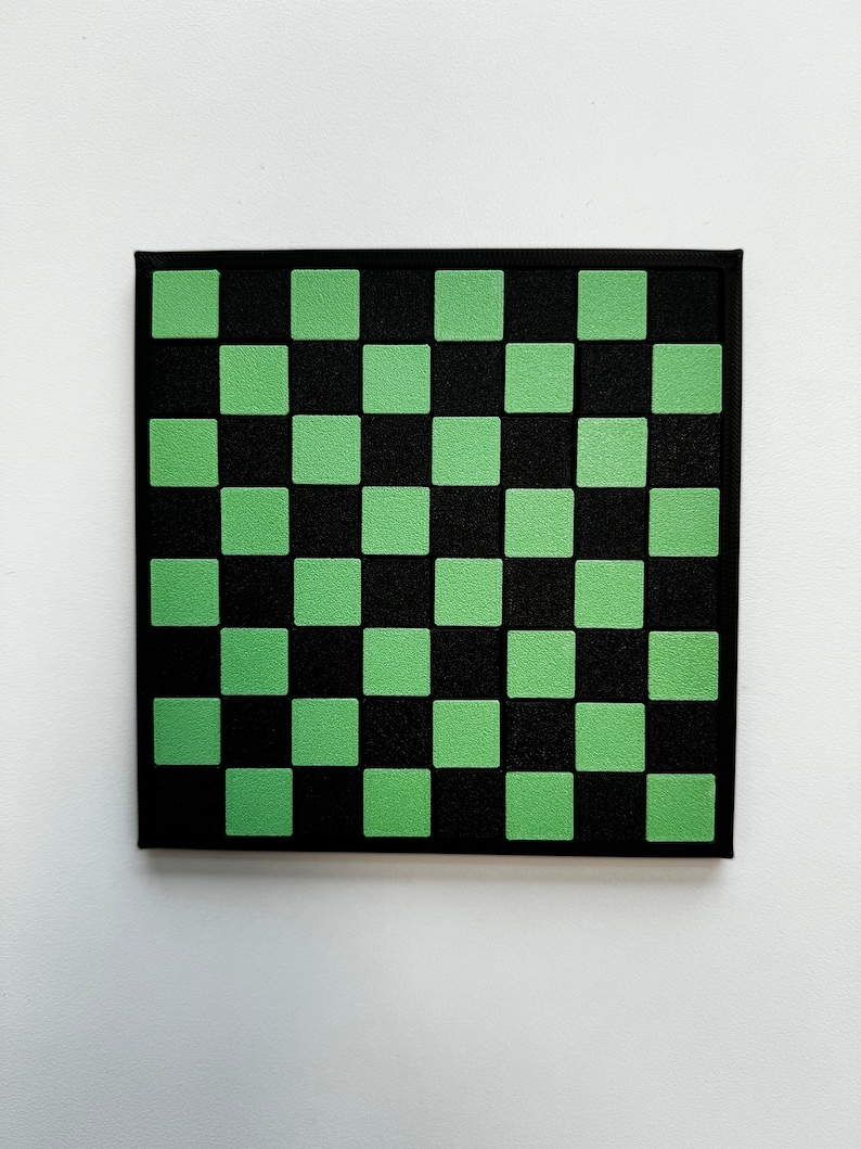 May include: A square canvas with a checkerboard pattern. The design features alternating black and light green squares. The canvas is framed with a black border, and the background is white.
