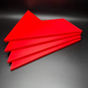 May include: Four red triangular pieces of acrylic stacked on top of each other.