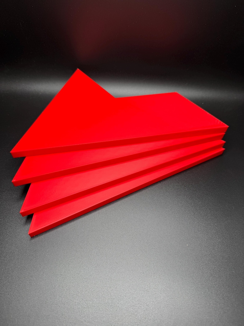 May include: Four red triangular pieces of acrylic stacked on top of each other.