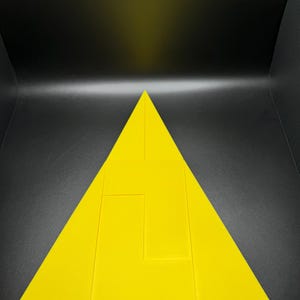 May include: A yellow triangle puzzle with four pieces. The puzzle is made of thick, solid material.