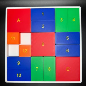 May include: A white square frame with a colorful puzzle inside. The puzzle pieces are numbered 1 through 12 and lettered A, B, and C. The puzzle pieces are red, blue, green, and orange.