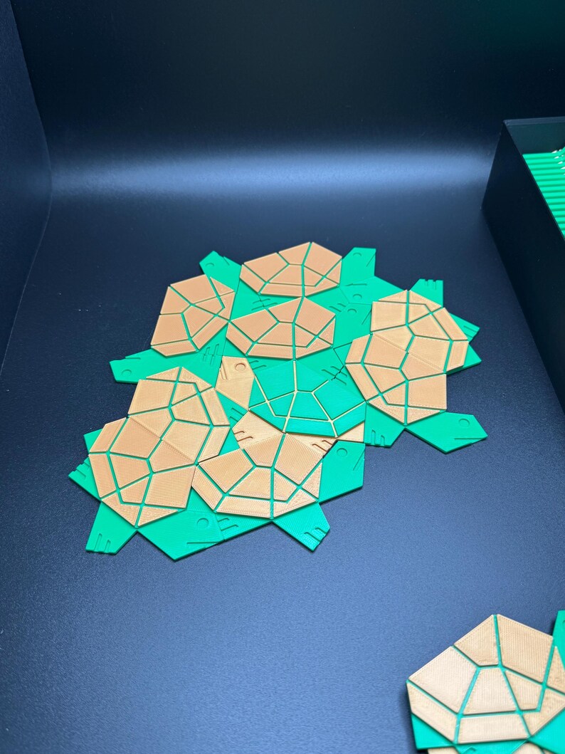 May include: A set of green and brown geometric tiles with a honeycomb pattern. The tiles are made of a lightweight material and are designed to be used for a variety of craft projects.
