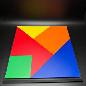 May include: A colourful wooden puzzle with seven pieces in red, orange, yellow, green, and blue. The pieces fit together to form a square.