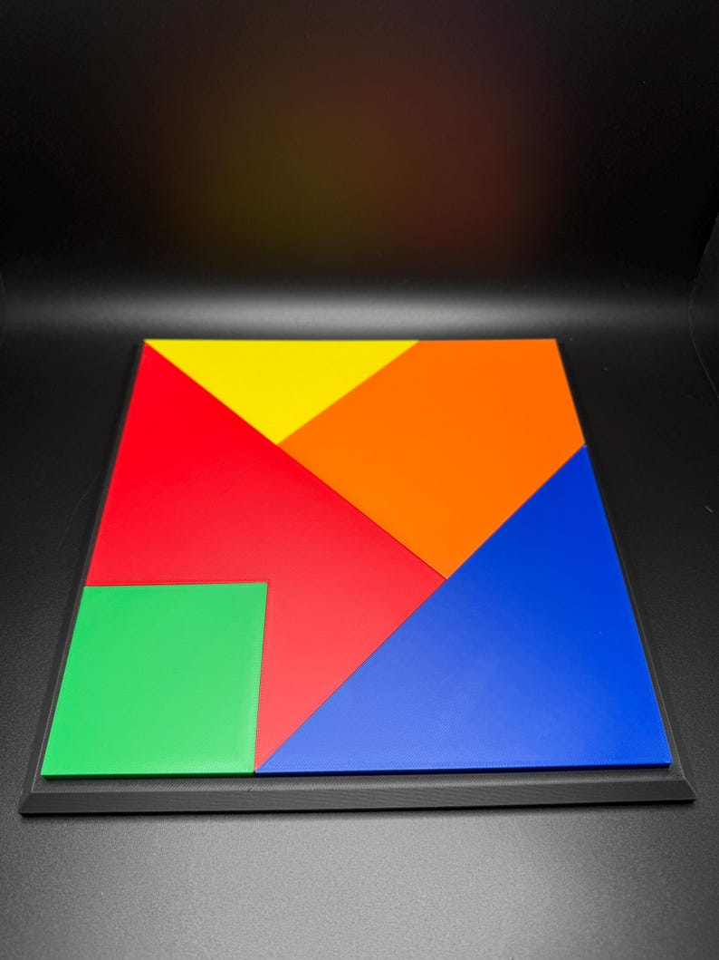 May include: A colourful wooden puzzle with seven pieces in red, orange, yellow, green, and blue. The pieces fit together to form a square.