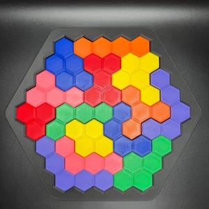 May include: A hexagonal puzzle featuring colourful honeycomb pieces in shades of red, orange, yellow, green, blue, and purple. The puzzle is made of plastic and is designed to be assembled into a larger hexagon shape.
