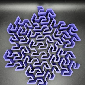 May include: A purple 3D printed snowflake maze with intricate pathways and a complex design.