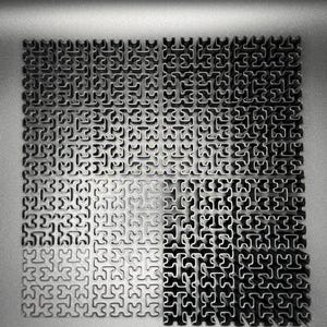 May include: A close-up of a metal surface with a repeating pattern of interlocking puzzle pieces. The surface is divided into four sections, with the top two sections appearing darker than the bottom two sections.