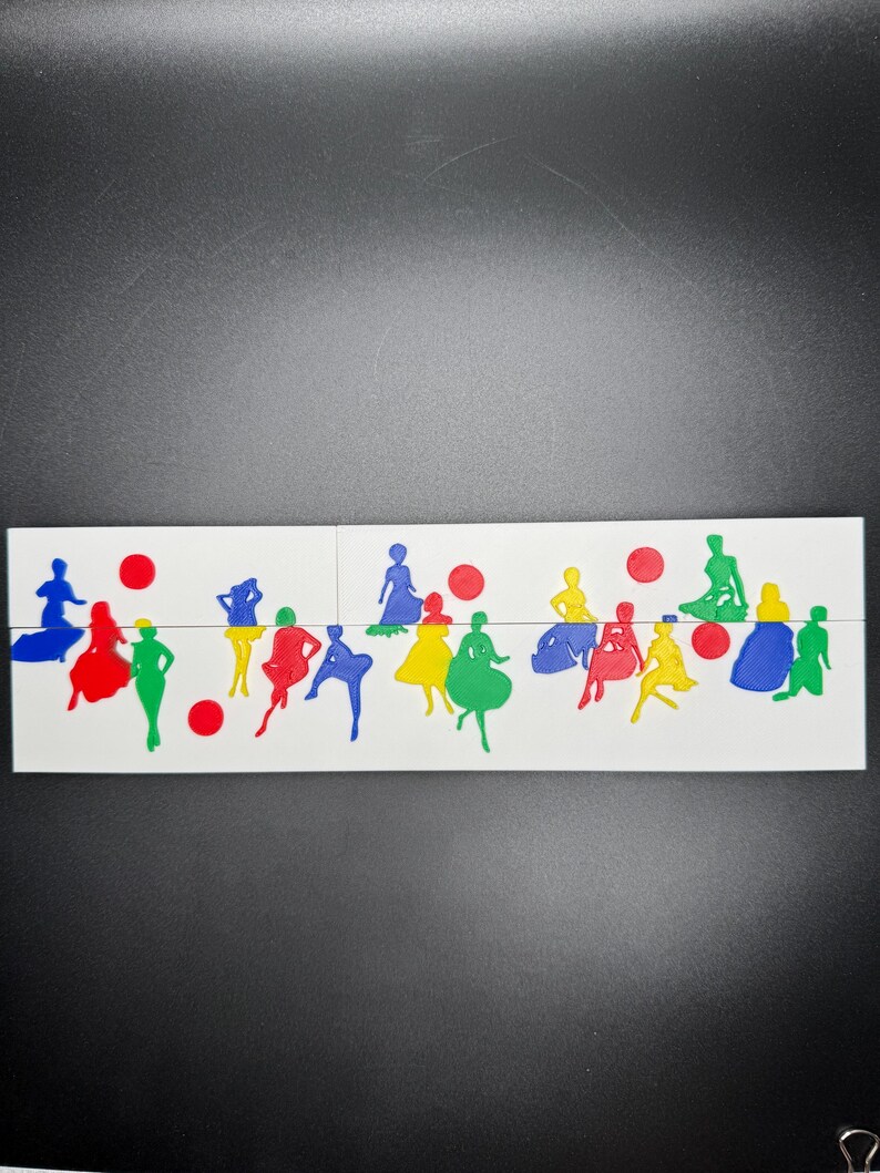 May include: A set of colorful, cutout figures of people in various poses. The figures are arranged in a row on a white surface. There are red circles scattered throughout the arrangement.