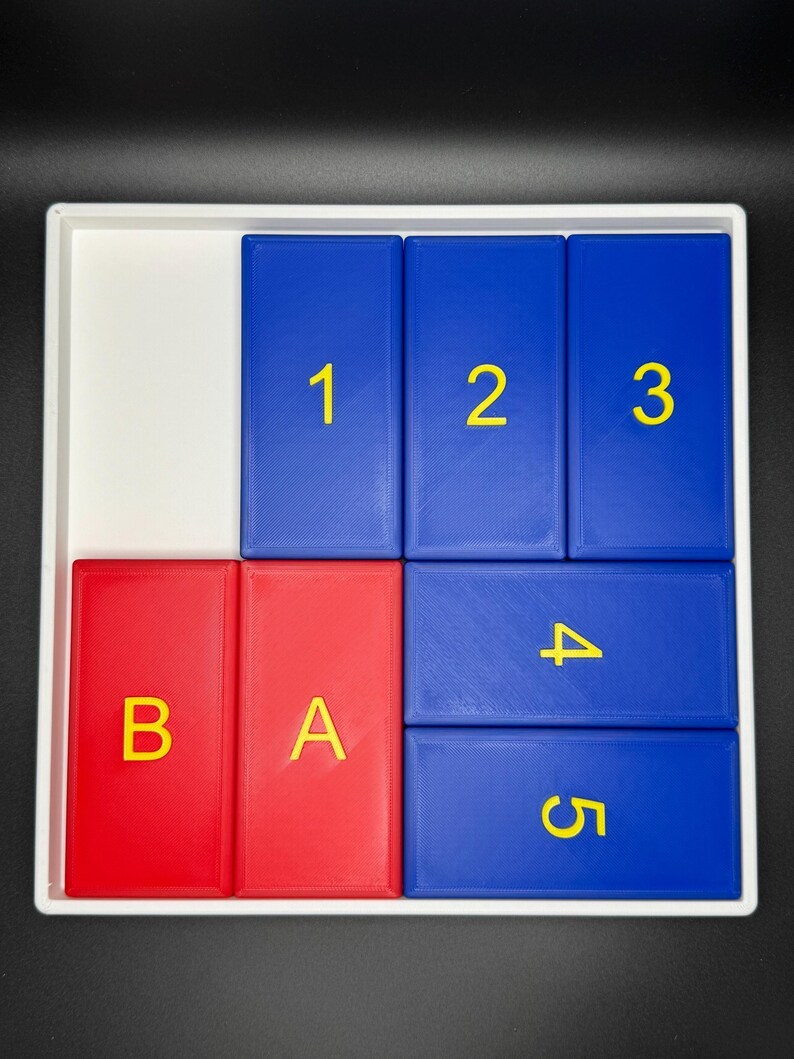 May include: A white tray with five blue and two red tiles. The blue tiles have the numbers 1, 2, 3, 4, and 5 printed in yellow. The red tiles have the letters B and A printed in yellow.