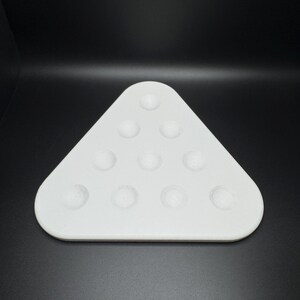 May include: White triangular tray with 12 circular indentations, designed for holding billiard balls.