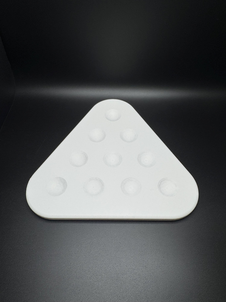 May include: White triangular tray with 12 circular indentations, designed for holding billiard balls.