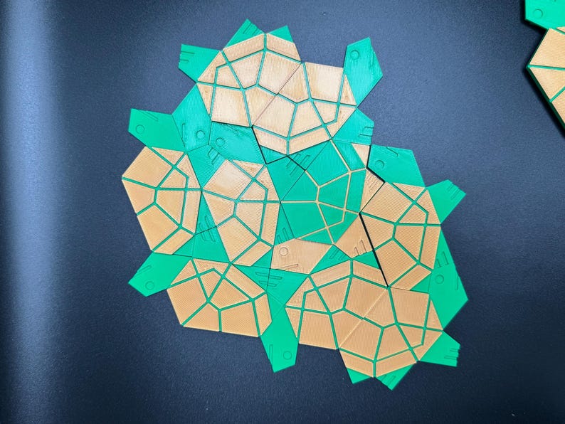 May include: A set of geometric shapes made of green and brown plastic. The shapes are arranged in a cluster, with the green shapes on top of the brown shapes.