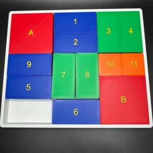 May include: A white frame with a grid of 12 squares. Each square is a different color: red, blue, green, and orange. The squares are numbered 1 through 11, and two squares are labeled with the letters A and B.