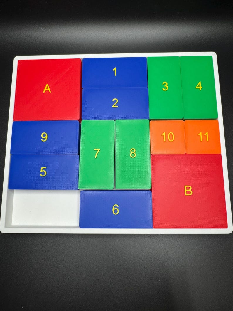 May include: A white frame with a grid of 12 squares. Each square is a different color: red, blue, green, and orange. The squares are numbered 1 through 11, and two squares are labeled with the letters A and B.