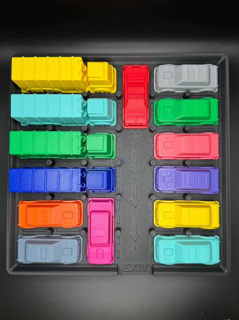 May include: A toy parking lot featuring a variety of brightly coloured vehicles. The set includes a yellow lorry, a teal truck, a green truck, a blue truck, an orange car, a grey car, a red truck, a pink car, a grey car, a green car, a pink car, a yellow car, and a teal car. The word "EXIT" is visible.